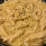 chicken and gravy crockpot meal in rustic kitchen