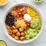 chipotle honey chicken recipe burrito bowl with guacamole, black beans, and grilled chicken
