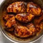 new hot honey glazed chicken in skillet with sticky glaze
